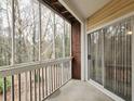 Covered patio with brick wall and sliding glass door overlooking wooded landscape at 6401 Wedgeview Ct # 6401, Tucker, GA 30084
