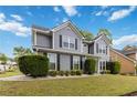 View of a gray two-story home, showcasing its well-maintained exterior and inviting curb appeal at 900 Hillary Ln, Lawrenceville, GA 30043
