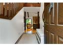 Warm and inviting entryway with hardwood floors, open staircase, and a glimpse into the cozy living space at 9295 Martin Rd, Roswell, GA 30076