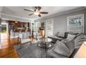 Bright living area featuring hardwood floors, a ceiling fan, and an adjoining kitchen at 1763 Delaware Ne Ave, Atlanta, GA 30307