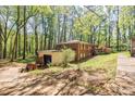 The house is nestled in the trees with a storage shed in the back at 2680 Irene Dr, Marietta, GA 30066