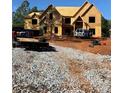 Exterior view of home under construction with exposed wood framing and a large lot at 409 Thunder Rd, Buford, GA 30518