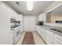 Clean, galley kitchen with white cabinets, granite countertops, and stainless steel appliances at 2605 Vineyard Se Way, Smyrna, GA 30082