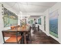 Open concept dining area with modern light fixture and hardwood floors at 3143 Church St, East Point, GA 30344