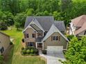Aerial view of home featuring a lush backyard, mature trees, and a well-maintained lawn at 8275 Majors Ridge Way, Cumming, GA 30041