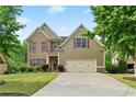 Two-story home featuring a brick and siding facade, well-manicured lawn, and two-car garage at 8275 Majors Ridge Way, Cumming, GA 30041