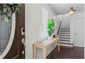 Bright foyer with hardwood floors, a console table, and stairs leading to the upper level at 1005 Glen Ivy, Marietta, GA 30062