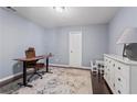 Office with dark wood floors, light blue walls, a white bureau, and a small desk with chair at 1005 Glen Ivy, Marietta, GA 30062