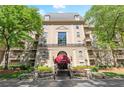 Beautiful view of the building's facade, featuring multiple balconies, a canopy, and manicured landscaping at 2865 Lenox Ne Rd # 504, Atlanta, GA 30324