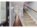 Inviting entryway with hardwood floors, staircase, and neutral walls, providing a warm welcome to the home at 6700 Roswell Rd # 19F, Atlanta, GA 30328