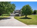 Inviting two-story home featuring a spacious front yard, a long driveway, and mature shade trees at 1076 Field View Dr, Mcdonough, GA 30253