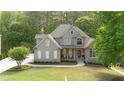 Charming two-story home with manicured lawn and inviting front porch at 1315 Woodland Trce, Cumming, GA 30041
