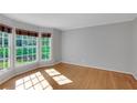 Bright room featuring natural lighting from large windows and hardwood flooring throughout at 1486 Kings Down Cir, Dunwoody, GA 30338