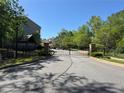 View of neighborhood entrance gate, offering security and privacy with manicured lawns on a sunny day at 1608 Falcon Crest Way # 58, Decatur, GA 30032