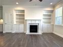 Bright living room featuring a fireplace, built-in shelving and hardwood floors at 1608 Falcon Crest Way # 58, Decatur, GA 30032