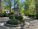 White Oak at East Lake entrance sign surrounded by colorful flowers, bushes, and mature trees along the road at 1608 Falcon Crest Way # 58, Decatur, GA 30032