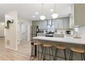 Stylish kitchen with barstool seating, stainless steel appliances, and updated countertops at 521 Smithstone Se Rd, Marietta, GA 30067