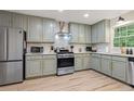 Well-appointed kitchen with stainless steel appliances, updated lighting, and gray tone cabinets at 521 Smithstone Se Rd, Marietta, GA 30067