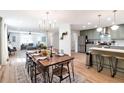 Spacious open layout of kitchen, dining and living area with modern lighting and stainless appliances at 521 Smithstone Se Rd, Marietta, GA 30067