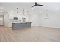 A large living room featuring an island, recessed lighting, hardwood floors and a ceiling fan at 170 Bluffington Way, Marietta, GA 30066