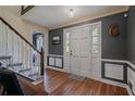 Inviting foyer with hardwood floors, staircase, and elegant decor showcasing a welcoming entrance at 4128 Mayflower Sw Ct, Lilburn, GA 30047