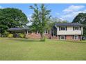 Inviting exterior showcases a manicured lawn and brick accents leading to a charming two-story home at 1548 Highway 81 W, Mcdonough, GA 30253