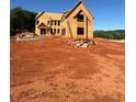 Exterior view of new home under construction showcasing framing, windows, and ladder at 407 Thunder Rd, Buford, GA 30518