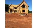 Exterior view of new home under construction showcasing framing, windows, and ladder at 407 Thunder Rd, Buford, GA 30518