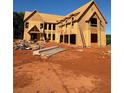 Exterior view of new home under construction showcasing framing, windows, and ladder at 407 Thunder Rd, Buford, GA 30518