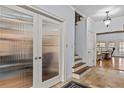 Entryway with stairs and double doors with reed glass at 2407 Honey Ct, Mcdonough, GA 30252