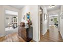 Spacious hallway with hardwood floors and views of the dining room and other living spaces at 3585 Legacy Trce, Alpharetta, GA 30022
