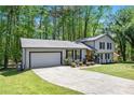 Desirable home boasts a spacious driveway, two-car garage, and lush landscaping at 2022 Ramblewood Ne Ct, Marietta, GA 30062
