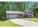 Well-maintained home with a long driveway, attached garage, and a neatly landscaped front yard at 2022 Ramblewood Ne Ct, Marietta, GA 30062