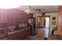 Traditional kitchen featuring wood cabinets, stainless steel appliances, and a gas cooktop at 4909 Woodhurst Way, Stone Mountain, GA 30088