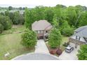 Aerial view of a well-maintained home with mature trees and a spacious driveway at 3097 Trinity Grove Dr, Dacula, GA 30019