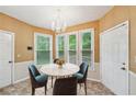 Cozy breakfast nook with large windows, a round table, and a charming chandelier at 10044 Point View Dr, Jonesboro, GA 30238