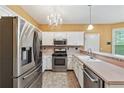 Bright kitchen with stainless steel appliances, tiled backsplash, and white cabinets at 10044 Point View Dr, Jonesboro, GA 30238