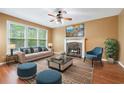 Bright living room with a fireplace, large windows, comfortable seating, and stylish decor at 10044 Point View Dr, Jonesboro, GA 30238