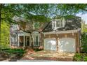 Beautiful two-story brick home featuring a two-car garage and manicured lawn at 1144 Bellewood Sq, Dunwoody, GA 30338
