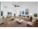 Bright, staged living room with a modern ceiling fan, hardwood floors, and plenty of natural light at 2215 Gordon Se Cir, Smyrna, GA 30080