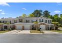 Charming townhome featuring attached garages, beautiful landscaping and inviting front entrances at 1067 Brittania Rd, Stone Mountain, GA 30083