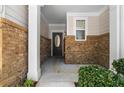 Inviting front porch featuring brick accents, columns and a stylish front door at 1067 Brittania Rd, Stone Mountain, GA 30083