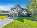 Attractive two-story home featuring lush green lawn and a well-maintained landscape at 2486 Ridgelake Dr, Villa Rica, GA 30180