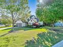 Beautiful home with a lush front yard, mature trees, and a two-car garage at 2486 Ridgelake Dr, Villa Rica, GA 30180