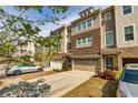Inviting townhouse showcasing a two-car garage, manicured lawn, and charming curb appeal at 2808 White Oak Ln, Decatur, GA 30032