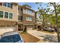 Attractive townhouse with a two-car garage, inviting entryway, and a well-manicured lawn at 2808 White Oak Ln, Decatur, GA 30032