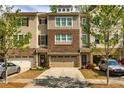 Well-maintained townhouse featuring a brick facade, neutral siding, and a convenient two-car garage at 2808 White Oak Ln, Decatur, GA 30032
