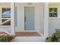Close up of a light blue front door with brick pavers and white brick accents at 1047 Winding Branch Ct, Atlanta, GA 30338