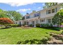 Charming two-story traditional home with manicured lawn, mature trees, and light blue shutters at 1047 Winding Branch Ct, Atlanta, GA 30338