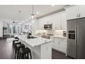 Modern kitchen featuring stainless steel appliances, marble countertops, pendant lighting and a peninsula with bar stool seating at 1050 Stacks Ave # 1507, Atlanta, GA 30315